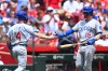 Chicago Cubs' Pete Crow-Armstrong, left, celebrates with Carson Kelly, right, after scoring on a double hit by Alex Bregman during the first inning of a baseball game against the Cincinnati Reds in Cincinnati, Sunday, July 12, 2026. (AP Photo/Ben Jackson)