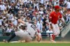 New York Yankees' Ben Rice, left, slides into third base for a two-RBI triple as Washington Nationals third baseman Jorbit Vivas, right, waits a the throw during the eighth inning of a baseball game, Sunday July 12, 2026, in Washington. (AP Photo/John McDonnell)
