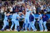 Texas Rangers' Brandon Nimmo, fourth from left, celebrates with the team after hitting a run-scoring single in the ninth inning of a baseball game against the Houston Astros in Arlington, Texas, Sunday, July 12, 2026. (AP Photo/Tony Gutierrez)