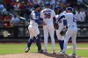 New York Mets players visit pitcher Devin Williams (38) on the mound during the ninth inning of a baseball game against the Boston Red Sox, Sunday, July 12, 2026, in New York. (AP Photo/Pamela Smith)