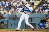 Los Angeles Dodgers' Shohei Ohtani hits a ground ball during the fifth inning of a baseball game against the Arizona Diamondbacks in Los Angeles, Sunday, July 12, 2026. (AP Photo/Kyusung Gong)
