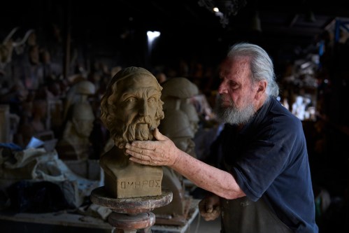 Sculptor and ceramicist Haralambos Goumas works on a terracotta bust of the ancient Greek poet Homer, the author of the Iliad and the Odyssey, at his workshop in the Athens suburb of Aigaleo, Wednesday, May 27, 2026. (AP Photo/Petros Giannakouris)