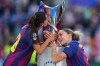 FILE - Barcelona's Kika Nazareth, left, and Mapi Leon touch the trophy after winning the Women's Champions League final soccer match between FC Barcelona and OL Lyonnes, in Oslo, Saturday, May 23, 2026. (AP Photo/Kirsty Wigglesworth, File)