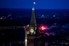 A small fireworks display is seen past the Peace Tower on Parliament Hill on Canada Day in Ottawa on Monday, July 1, 2024. THE CANADIAN PRESS/Justin Tang