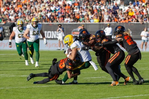 Edmonton Elks' Austin Mack (3) is swarmed by the B.C, Lions defence during second half CFL football action in Kelowna, B.C., on Saturday July 4, 2026. THE CANADIAN PRESS/Steve Dunsmoor