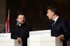Ukrainian President Volodymyr Zelensky, left, and French President Emmanuel Macron address a press conference after the Coalition of the Willing summit on security guarantees for Ukraine in Paris, Monday, July 13, 2026. (Teresa Suarez/Pool Photo via AP)