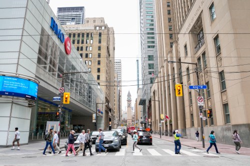 A general view of pedestrians crossing Bay St. in the financial district in Toronto, Friday, Sept. 8, 2023. THE CANADIAN PRESS/Andrew Lahodynskyj