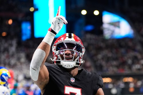 FILE - Atlanta Falcons running back Bijan Robinson (7) celebrates his touchdown reception against the Los Angeles Rams in the first half of an NFL football game, Dec. 29, 2025, in Atlanta. (AP Photo/Brynn Anderson, File)
