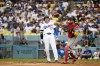 Los Angeles Dodgers' Shohei Ohtani (17) reacts as Arizona Diamondbacks catcher Gabriel Moreno throws during the third inning of a baseball game in Los Angeles, Sunday, July 12, 2026. (AP Photo/Kyusung Gong)