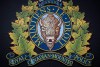 The RCMP logo is seen in Surrey, B.C., Mounties say they have charged a man with human smuggling and arrested eight African migrants near the Canada-U.S. border in Manitoba. THE CANADIAN PRESS/Darryl Dyck
