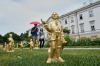People pass 400 gold colored plastic Mozart sculptures by German artist Ottmar Hoerl from Nuremberg before the 270th birthday of composer Wolfgang Amadeus Mozart in Salzburg, Austria, Wednesday, July 15, 2026. (AP Photo/Matthias Schrader)