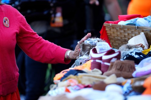 An attendee places children's shoes in memory of victims of Canada's residential school system during a ceremony on Truth and Reconciliation Day in Ottawa on Monday, Sept. 30, 2024. THE CANADIAN PRESS/Sean Kilpatrick