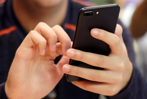 FILE - A person uses a smart phone in Chicago, Sept. 16, 2017. (AP Photo, File)