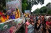 Hindu devotees gather around tableau with Hindu mythological characters Krishna and Radha as they participate in a religious procession during the Rath Yatra, or chariot festival, carrying the Hindu deities of Jagannath, Balaram and Subhadra, in Kolkata, India, Thursday, July 16, 2026. (AP Photo/Bikas Das)
