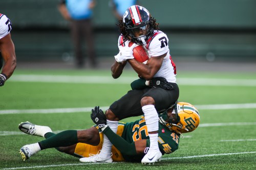Edmonton Elks' Dariel Djabome (45) tackles Ottawa Redblacks' Kalil Pimpleton (83) during first half CFL football action in Edmonton on Thursday, July 9, 2026. THE CANADIAN PRESS/Codie McLachlan