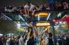 Fans climb on to a bus stop during celebrations of Argentina's victory over England in a World Cup semifinal soccer match in downtown Buenos Aires, Argentina, Wednesday, July 15, 2026. (AP Photo/Rodrigo Abd)