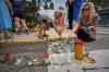 Mourners place flowers and candles in Biddeford, Maine, Wednesday, July 15 2026, near the blood-stained pavement where Johan Sebastián Durán Guerrero was pulled from his car on Monday by U.S. Immigration and Customs Enforcement agents. (AP Photo/Robert F. Bukaty)