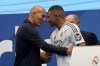 FILE - Former French player Zinedine Zidane, left, embraces Kylian Mbappe of France, as he is being presented to fans as a new Real Madrid player in Madrid, July 16, 2024. (AP Photo/Andrea Comas, File)