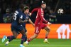 FILE - Liverpool's Dominik Szoboszlai, right, challenges for the ball with PSG's Joao Neves and PSG's Nuno Mendes during the Champions League quarterfinal first leg soccer match between Paris Saint-Germain and Liverpool in Paris, April 8, 2026. (AP Photo/Thibault Camus, File)