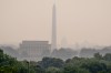 The Lincoln Memorial, the Washington Monument, and the U.S. Capitol, are barely visible from an overlook in Arlington, Va., as heavy smoke from wildfires shrouds the landscape in Washington, Friday, July 17, 2026. (AP Photo/J. Scott Applewhite)