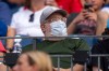 A fan wears a mask during an air quality warning from wildfire smoke prior to baseball game between the New York Mets and the Philadelphia Phillies, Thursday, July 16, 2026, in Philadelphia. (AP Photo/Chris Szagola)