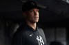 New York Yankees' Aaron Judge looks on from the dugout during the third inning of a baseball game against the Los Angeles Dodgers, Friday, July 17, 2026, in New York. (AP Photo/Adam Hunger)