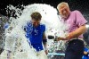 Kansas City Royals' Carter Jensen with commentator Joel Goldberg are doused by teammates after their baseball game, Friday, July 17, 2026, in Kansas City, Mo. (AP Photo/Charlie Riedel)