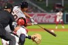 Detroit Tigers' Hao-Yu Lee, center, hits a two RBI double as Los Angeles Angels catcher Logan O'Hoppe, right, and home plate umpire Will Little watch during the ninth inning of a baseball game Friday, July 17, 2026, in Anaheim, Calif. (AP Photo/Mark J. Terrill)
