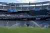FILE - Sprinklers water the grass during the pitch installation for FIFA World Cup 2026 at NYNJ Stadium, Thursday, May 7, 2026, in East Rutherford, N.J. (AP Photo/Yuki Iwamura, File)
