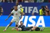 England's Morgan Rogers (17) and Argentina's Lionel Messi (10) fight for the ball during the World Cup semifinal soccer match between England and Argentina in Atlanta, Wednesday, July 15, 2026. (AP Photo/Stephanie Scarbrough)