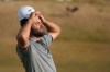 Scottie Scheffler of the United States adjusts his hat on the 18th green during the third day of the British Open Golf championships at Royal Birkdale golf club, in Southport, England, Saturday, July 18, 2026. (AP Photo/Jon Super)