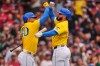 Boston Red Sox's Wilyer Abreu, right, is congratulated by Willson Contreras after hitting a solo home run in the third inning of a baseball game against the Tampa Bay Rays, Saturday, July 18, 2026, in Boston. (AP Photo/Charles Krupa)
