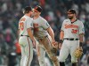 Baltimore Orioles relief pitcher Cam Sanders, left, celebrates with Pete Alonso, center, and Christian Encarnacion-Strand, right, after a baseball game against the Houston Astros, Saturday, July 18, 2026, in Houston. (AP Photo/Karen Warren)