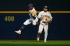 Milwaukee Brewers center fielder Luis Lara (18) makes a running catch in front of center fielder Garrett Mitchell (5) on a fly ball hit by Miami Marlins' Javier Sanoja during the eighth inning of a baseball game Saturday, July 18, 2026, in Milwaukee. (AP Photo/Kayla Wolf)