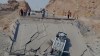 An overturned car sits on a section of a destroyed bridge after a strike in Hormozgan province, southern Iran, Saturday, July 18, 2026. (Mahdi Negahban/Mehr News Agency via AP)