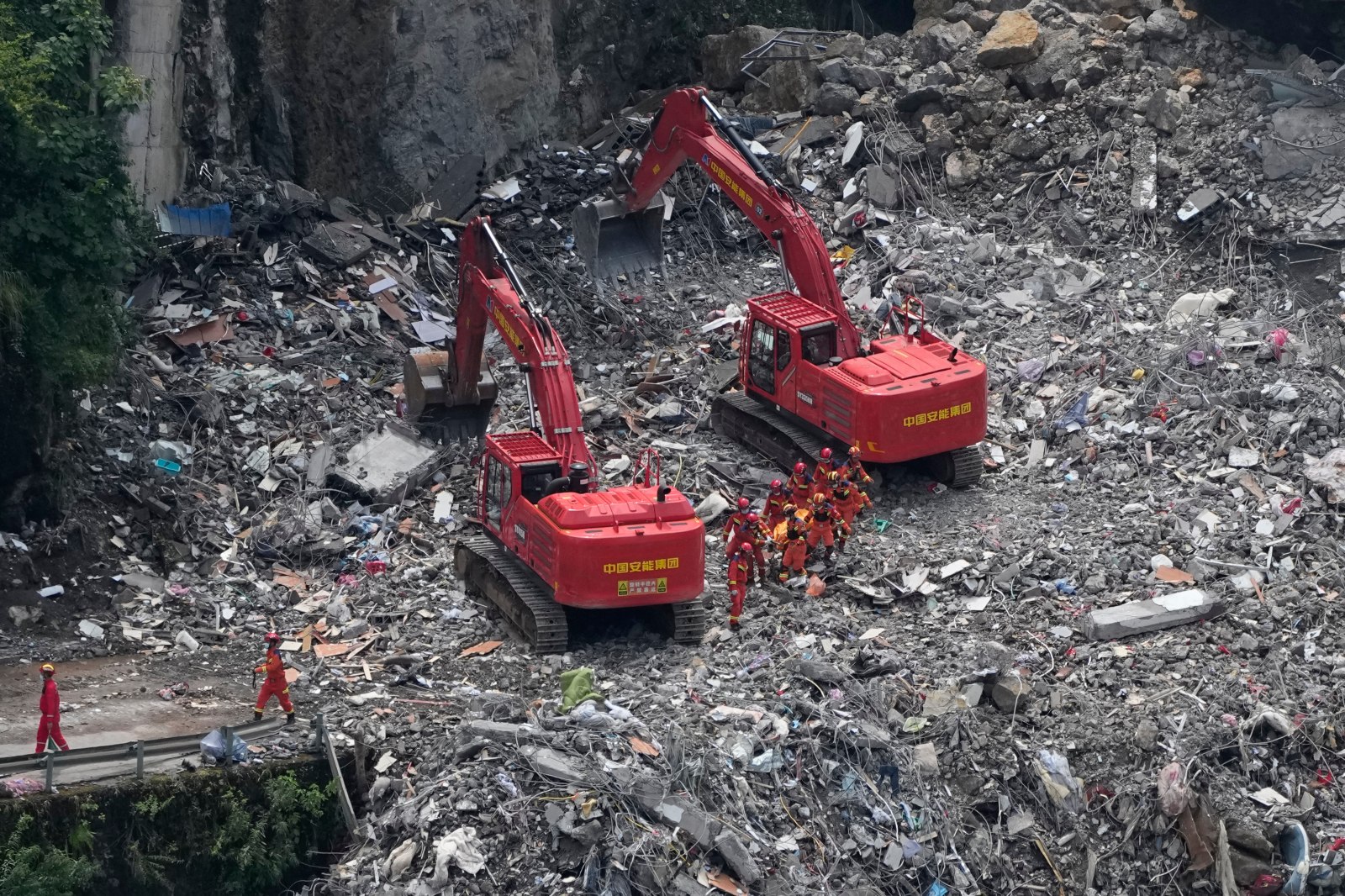 Rescuers in China search the rubble for survivors of landslide that killed 8 and left 34 missing