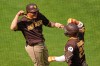San Diego Padres' Ty France (25) celebrates with Manny Machado, left, after hitting a grand slam during the eighth inning of a baseball game against the Kansas City Royals, Sunday, July 19, 2026, in Kansas City, Mo. (AP Photo/Charlie Riedel)