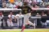 Pittsburgh Pirates' Esmerlyn Valdez (55) gestures as he runs toward home plate with a home run in the ninth inning of a baseball game against the Cleveland Guardians in Cleveland, Sunday, July 19, 2026. (AP Photo/Sue Ogrocki)