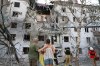 Residents look at their ruined home following a Russian air guided bomb strike in Zaporizhzhia, Ukraine, Sunday, July 19, 2026. (AP Photo/Kateryna Klochko)