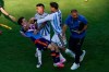 Spain's Gavi, left, falls as he scuffles with Argentina's Leandro Paredes (5) and Thiago Almada during the World Cup final soccer match between Spain and Argentina in East Rutherford, N.J., near New York, Sunday, July 19, 2026. (AP Photo/Yuki Iwamura)