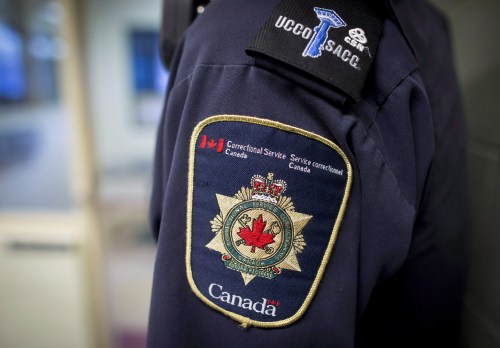Patches are seen on the arm and shoulder of a corrections officer in Abbotsford, B.C., on Thursday Oct. 26, 2017. THE CANADIAN PRESS/Darryl Dyck