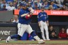 Toronto Blue Jays' Alejandro Kirk (30) hits an RBI single against the Tampa Bay Rays, scoring teammate George Springer during fourth inning MLB baseball action in Toronto on Monday, July 20, 2026. THE CANADIAN PRESS/Jon Blacker