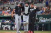 Chicago White Sox catcher Kyle Teel, center, his helped off the field by manager Will Venable (1) and trainer Brett Walker, right, during the second inning of a baseball game against the Texas Rangers, Monday, July 20, 2026, in Arlington, Texas. (AP Photo/LM Otero)