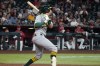 Athletics' Jeff McNeil hits a two-run single against the Arizona Diamondbacks in the seventh inning of a baseball game, Monday, July 20, 2026, in Phoenix. (AP Photo/Rick Scuteri)