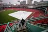 Fans leave the upper deck of Fenway Park after a baseball game between the Boston Red Sox and Baltimore Orioles was postponed due to heavy rain, Tuesday, July 21, 2026, in Boston. (AP Photo/Charles Krupa)