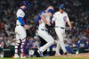 Chicago Cubs relief pitcher Trent Thornton, center, is helped by a team trainer after an injury during the 10th inning of a baseball game against the Detroit Tigers in Chicago, Monday, July 20, 2026. (AP Photo/Nam Y. Huh)