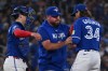 Toronto Blue Jays pitcher Kevin Gausman (34) is taken out of the game against the Tampa Bay Rays by manager John Schneider, centre, during the fourth inning of their MLB game in Toronto on Tuesday, July 21, 2026. THE CANADIAN PRESS/Jon Blacker