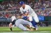 Texas Rangers third baseman Josh Jung, right, tags out Chicago White Sox's Sam Antonacci, left, between third and home plate on a fielder's choice during the first inning of a baseball game, Monday, July 20, 2026, in Arlington, Texas. (AP Photo/LM Otero)