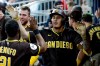 San Diego Padres' Manny Machado is greeted in the dugout after hitting a solo home run against the Atlanta Braves during the sixth inning of a baseball game, Tuesday, July 21, 2026, in Atlanta. (AP Photo/Erik S. Lesser)