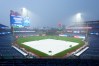 A tarp covers the field as rain falls, delaying the start of the baseball game between the Los Angeles Dodgers and the Philadelphia Phillies, Tuesday, July 21, 2026, in Philadelphia. (AP Photo/Chris Szagola)